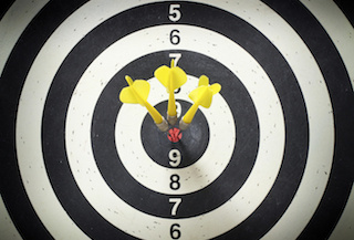 Bullseye with three darts in the center